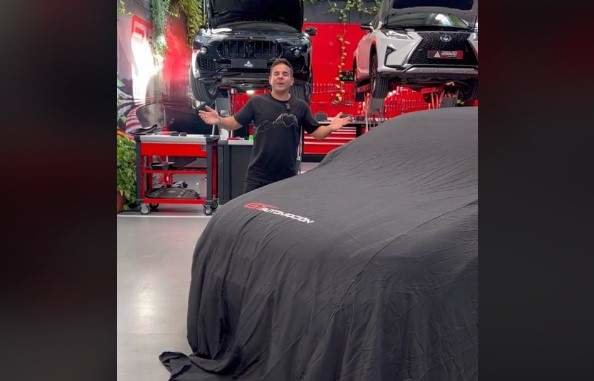 Ángel Gaitán en su taller junto al coche que sorteará entre sus seguidores